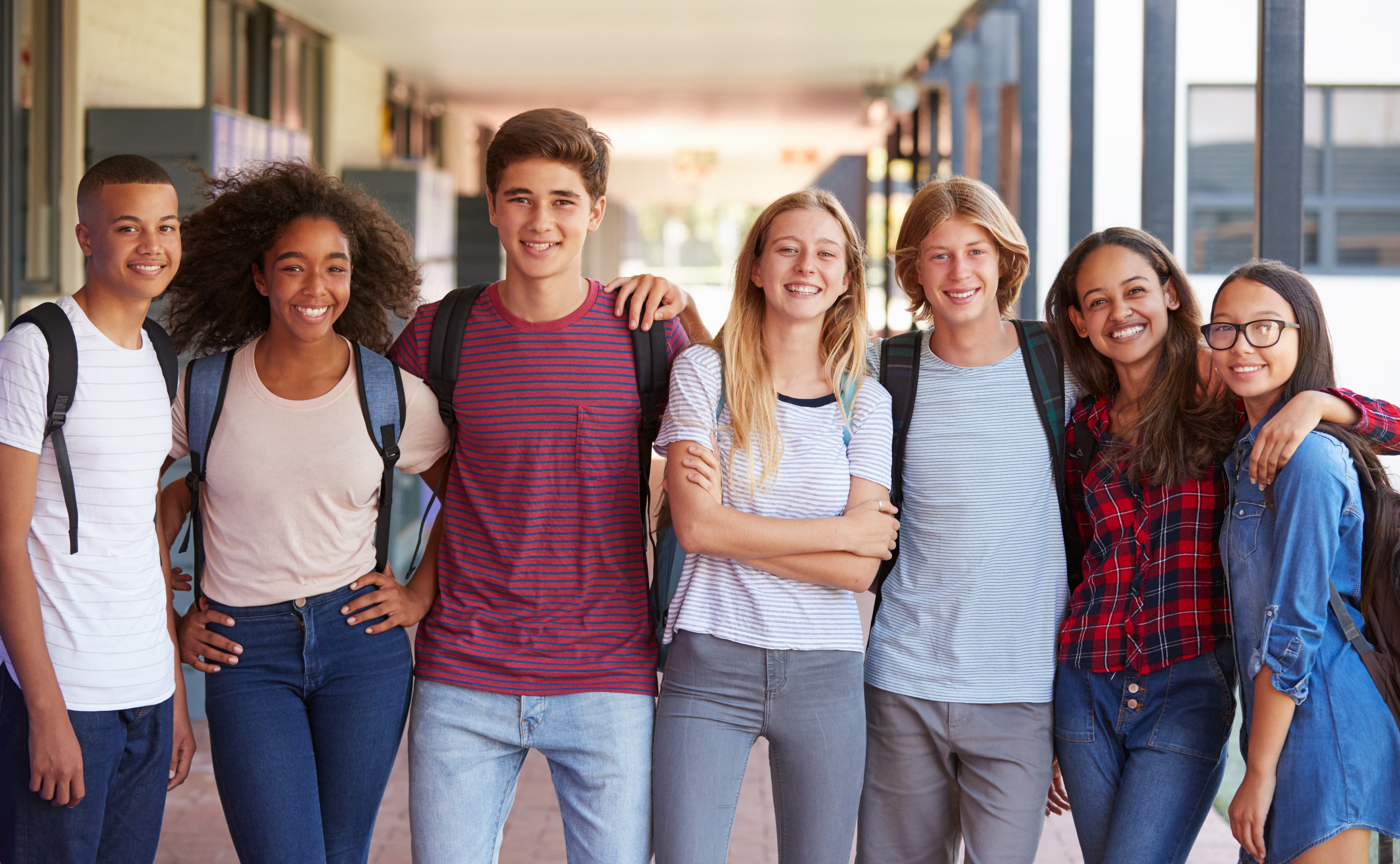 A picture of a diverse group of students in the hallway of a university
